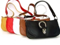 Designer Inspired Handbag has a top zipper closure, a single strap, and a strap with a push lock closure. Made of faux leather.