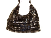 PVC fashion Hobo Handbag has studded details has a metallic texture, a top zipper closure, and a single strap. Made of faux leather.