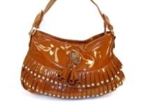 Fashion shoulder bag has a top zipper closure, a single strap and layered frilla with stud details on them. Made of PVC.