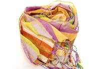 Stripes in multi colors galore over this shiny polyester scarf with also lines of translucent sequins along its length. Thin fringes on its ends completes this 100% polyester scarf. Hand wash. Imported.