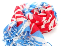 The British flag patterns this finely woven, lightweight wool scarf in ivory, turquoise & red colors with twisted fringe at the ends of the scarf. Imported from India. Dry clean only.