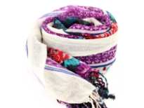 Add a punch of color with this black vivid wool scarf patterned with floral design in blue, red & purple colors and cream colored border along the vertical length. Hanging fringe decorates the ends. 100% woolen scarf. Hand wash. Imported.