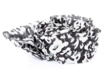 Black 100% cotton scarf with white floral print on it. This breezy lightweight scarf is a must have all year around. Imported. Hand wash.