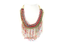 Links design gold tone brass necklace intertwined with multi color braided thread & studs like hot pink resins. Hanging chains & resins in multi colors gives a bib look to this statement necklace. Imported.