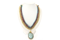Two tone braided thread & metal gold tone links chain are intertwined to make this beautiful neck piece which also has a hanging oval pendant in resin. Small blue rhinestones decorate this necklace all over.