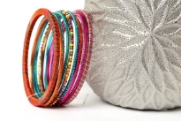 Colorful & lightweight 12 pieces bangles set can be matched with any kind of outfit. 9 thin glittery bangles, one thin beaded bangle & 2 threaded bangles - one fuchsia/blue & one orange/multi colored. Hand crafted in India.