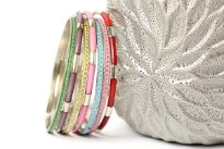 This is a 7 piece set of bangle bracelets in assorted colors. Handcrafted by expect artisans in India.