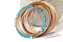 Colorful & Fashionable set of 13 Pieces includes a wooden bangle, a turquoise metal bangle with floral metal design & glittery thin bangles in resin material. Hand crafted & very lightweight.