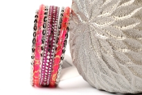 Shiny & Glittery seven piece set of fashion bangles in hot pink hues includes one wide Fuchsia bangle in Aluminium with mirrors design on it, 2 hot pink resin bangles with gold glitter inside them & 4 thin silver bangles. Hand crafted in India.